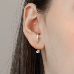 Close-up of S925 sterling silver snake texture ear cuff earring on earlobe