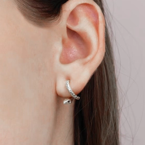 Macro view of sterling silver snake earring featuring detailed scale texture and snake head