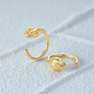 Detailed view of snake head earring with scale textures and bright gold finish