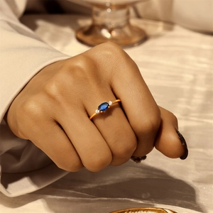 Close-up of elegant S925 silver ring with oval blue gemstone and white zircon accents