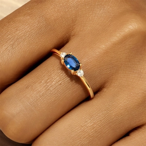 Detail of vintage S925 silver ring with oval blue sapphire and zircon accents