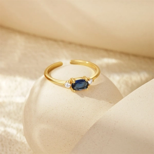 Macro detail of S925 sterling silver stamp on golden ring with oval blue gemstone