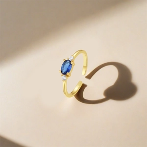 Macro view of S925 sterling silver gold plated ring with blue oval zircon and hallmark