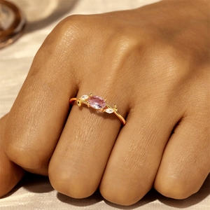 Close-up of a vintage S925 silver ring with an oval pink gemstone and leaf details