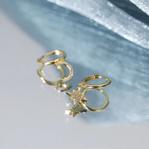 Detailed close-up of S925 silver asymmetric star and moon hoop earrings with zircon