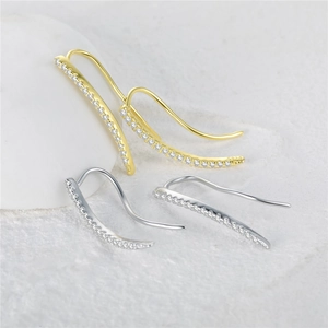Detailed macro view of S925 sterling silver curved climber earrings with pavé crystals