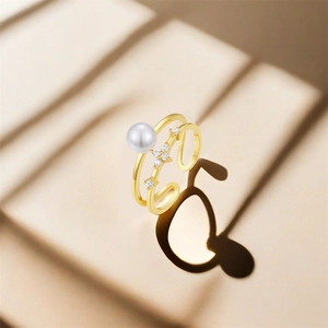 Detail of double-layer silver ring with white pearl and floral zircon accents