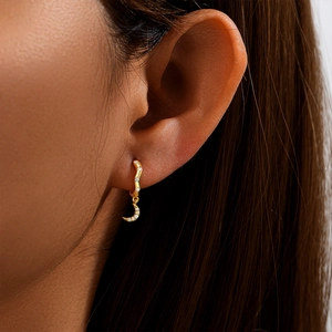 Close-up of gold-plated S925 silver moon drop earring with sparkling zircon stones