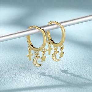 Detailed macro view of S925 sterling silver stamp on gold moon and star earrings