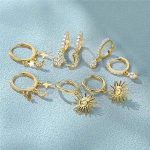Macro detail showing the S925 hallmark on gold-plated sterling silver star and moon earrings
