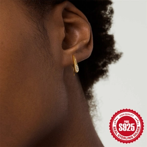 Elegant gold-plated S925 sterling silver teardrop earrings with crystals on a female model