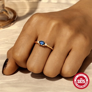 Vintage S925 sterling silver ring with oval blue gemstone and round side diamonds