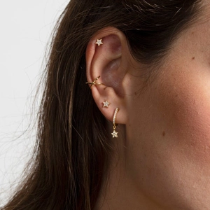 Detailed view of S925 silver gold-plated star and moon mismatched earrings and ear cuffs