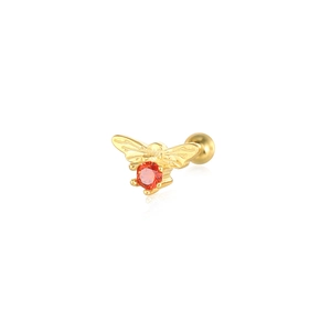 Detailed macro view of a gold bee stud earring with a red zircon gemstone on a white background