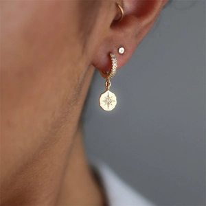 Detailed close-up of S925 silver star hoop earring in gold finish with zircon inlay