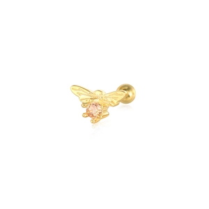 Macro shot of gold bee cartilage earring featuring wings texture and orange zircon