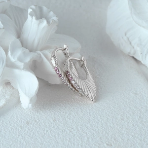 Macro shot of S925 sterling silver fan-shaped earrings with pink and white cubic zirconia