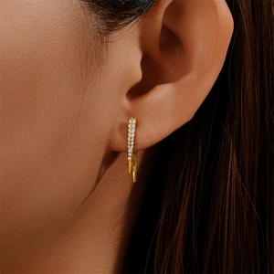 Macro view of S925 sterling silver stamp and vertical pavé crystals on golden fan earring