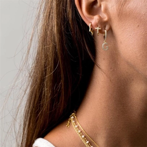 Detail of layered gold necklaces with pearls and multi-style drop earrings set
