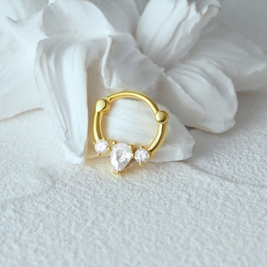 Detail of s925 silver nose ring with gold plating and pear-shaped cubic zirconia