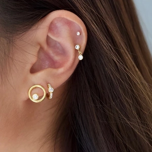 Detail of S925 silver gold-plated cluster stud earrings set with zircon on ear