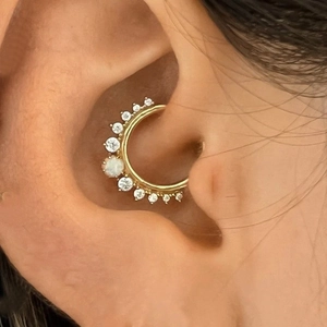 Detail of s925 silver gold ear hoop with marquise opal and sparkling zirconia on ear