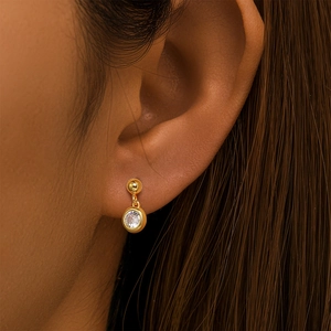 Close-up of elegant gold S925 silver stud earring featuring a brilliant round cut zircon