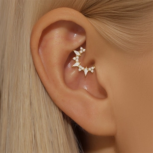 Macro shot of s925 silver gold-plated cartilage hoop with opal and sparkling cubic zirconia