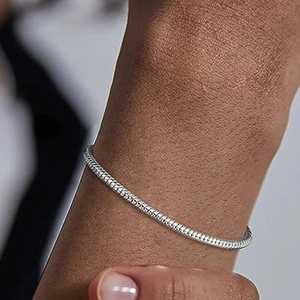 Close-up of minimalist s925 silver snake bone chain bracelet worn on a male wrist