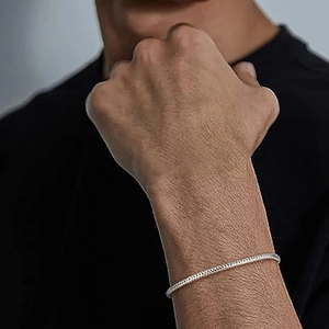 Close-up of minimalist S925 sterling silver snake chain bracelet on a male wrist