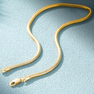 Close-up of golden snake chain bracelet with polished texture and lobster clasp