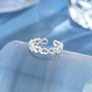 Macro view of S925 silver open ring featuring a continuous hollow heart pattern design