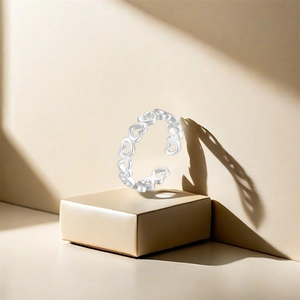 Detailed close-up of S925 sterling silver adjustable open ring with hollow heart patterns