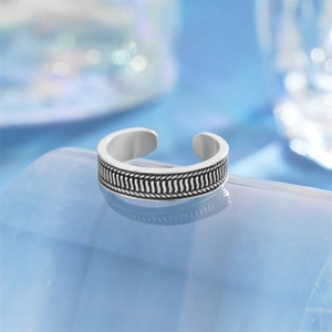 Detail of vintage silver toe ring featuring intricate oxidized lotus woven textures