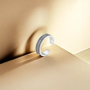 Macro shot of S925 sterling silver toe ring with woven texture and purity stamp