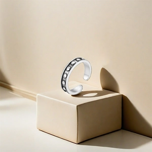 Detail of s925 silver toe ring with vintage dot relief and oxidized finish