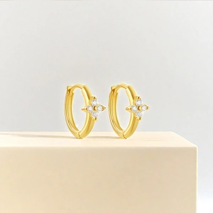 Close-up of gold S925 sterling silver hoop earrings with zircon floral charms