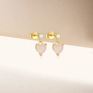 Dettaglio di orecchini a cuore in argento S925 con gemma rosa e zircone rotondo