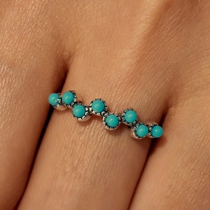 Detail of s925 silver wave ring with round turquoise stones in retro bohemian style