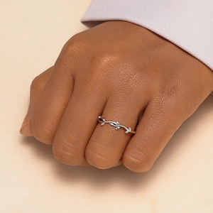 Macro detail of S925 sterling silver ring with delicate leaf pattern on a slender band