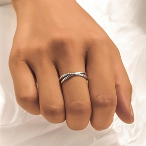 Detail of s925 silver double layered ring with braided texture on model finger