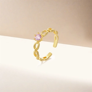 Detail of S925 sterling silver chain ring with pink zircon stone and gold plating