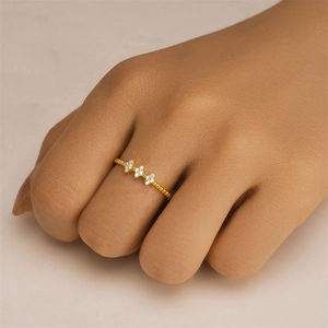 Detailed view of a gold beaded ring featuring three sparkling star-shaped zirconias