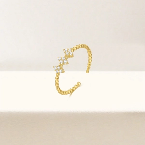 Detail of beaded gold ring featuring vertical cross motifs and cubic zirconia stones