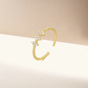 Detail of adjustable S925 silver ring with golden finish and white zircon flower clusters
