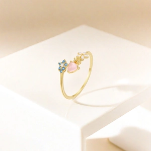 Detail view of S925 silver ring featuring blue flower and pink heart gemstone