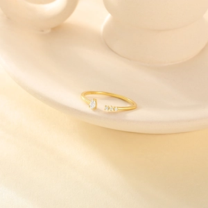 Detailed shot of S925 silver stamp on gold-plated open ring with sparkling cubic zirconia