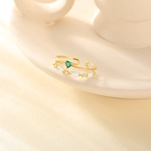 Close-up of double-layer gold plated ring with green heart zircon and white gemstones