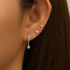 Close-up of S925 sterling silver four-petal flower earrings with zircon pavé