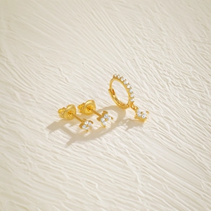 Detail of S925 silver gold-plated clover earrings set with zircon micro-pave